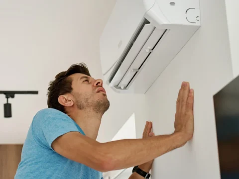 AC blowing warm air on a hot day